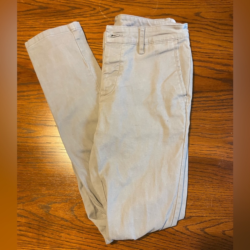 ASOS- men’s light grey trousers with button closure.